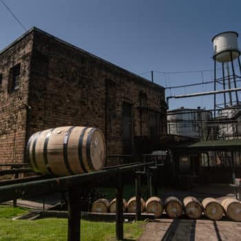 bourbon barrel on tracks, rolling toward the warehouse