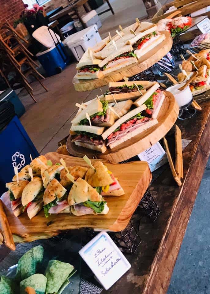 Various sandwiches and wraps displayed on a table for an event.