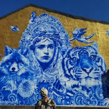 Mural of girl, tiger, fox, and bird on the side of Bourbon on Main