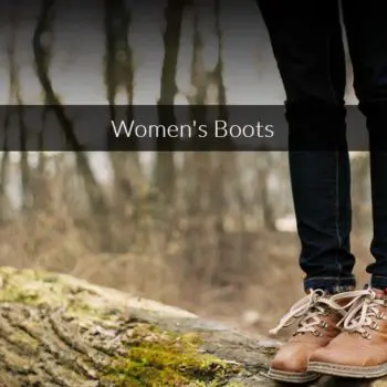 pic of a womens legs from just above the knee, down,wearing black pants and brown hiking boots, standing on a tree