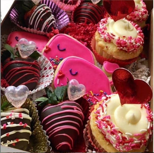 Image of heart shaped and smiling whale cookies and chocolate covered strawberries