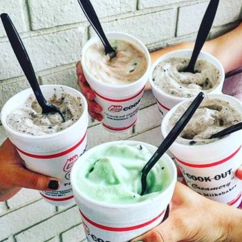 image of hands holding 5 different milkshakes in a circle