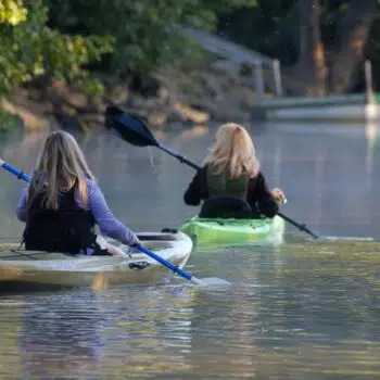 Two women kayaking.