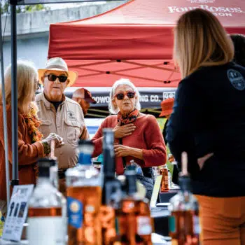 People at booth at Bourbon on the Banks