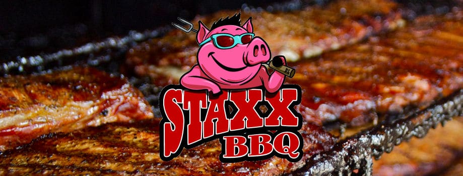 ribs on the grill with Staxx logo of a cartoon pig in sun glasses